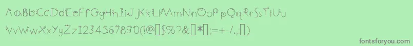 DecemberDeco-Schriftart – Graue Schriften auf grünem Hintergrund