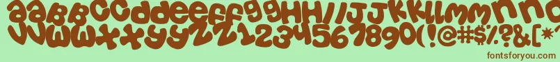 Tosscasu Font – Brown Fonts on Green Background