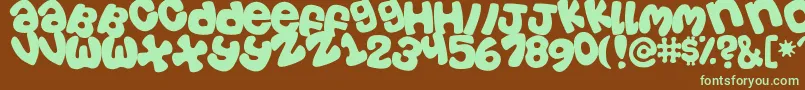 Tosscasu Font – Green Fonts on Brown Background