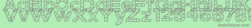 StampedNavyFont-fontti – harmaat kirjasimet vihreällä taustalla