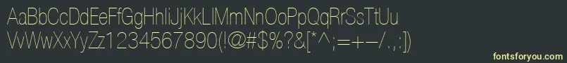 フォントHelveticaLt27UltraLightCondensed – 黒い背景に黄色の文字