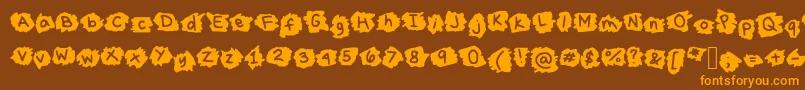 フォントMissTerious – オレンジ色の文字が茶色の背景にあります。