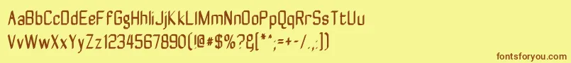 フォントZyphytecondense – 茶色の文字が黄色の背景にあります。