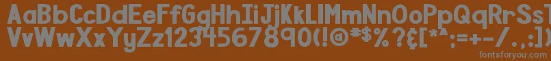 DjbSpeakTheTruthBoldly-fontti – harmaat kirjasimet ruskealla taustalla