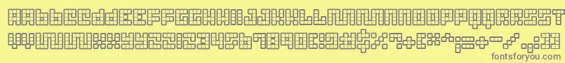 フォントTricb – 黄色の背景に灰色の文字