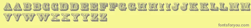 フォントLettres – 黄色の背景に灰色の文字