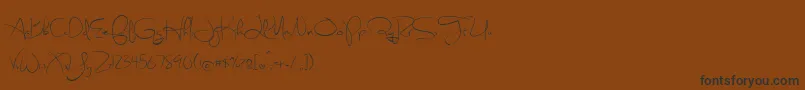 フォントSweetlyBroken – 黒い文字が茶色の背景にあります