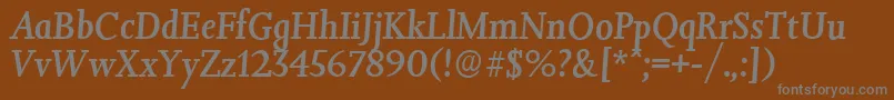 JessicaserialMediumItalic-fontti – harmaat kirjasimet ruskealla taustalla