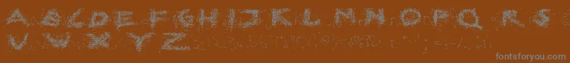 BrokenEverywhereRegular Font – Gray Fonts on Brown Background