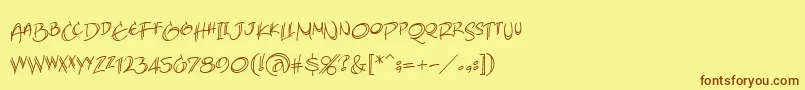 フォントAtlandsketchesBb – 茶色の文字が黄色の背景にあります。