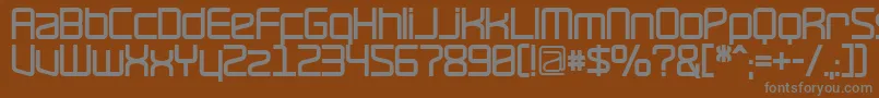 RavepartyBold-fontti – harmaat kirjasimet ruskealla taustalla