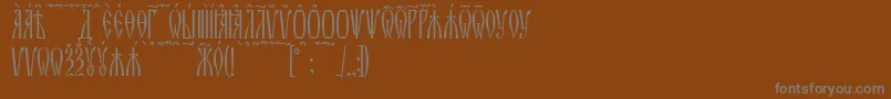 ZlatoustKucs-Schriftart – Graue Schriften auf braunem Hintergrund