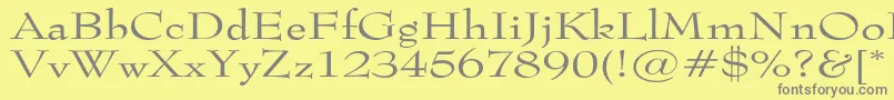 フォントTophatextended – 黄色の背景に灰色の文字