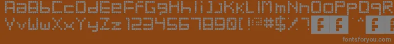 RetroParty-fontti – harmaat kirjasimet ruskealla taustalla