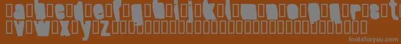 SplumpBlack-fontti – harmaat kirjasimet ruskealla taustalla