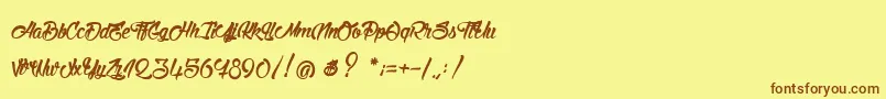 フォントStinkOnTheDeath – 茶色の文字が黄色の背景にあります。