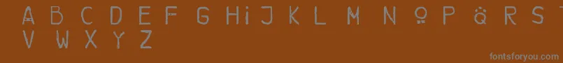 フォントBrotherbear – 茶色の背景に灰色の文字