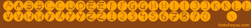 Inkalphabetinvers-fontti – oranssit fontit ruskealla taustalla