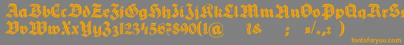 フォントHermannGotischDecoc – オレンジの文字は灰色の背景にあります。