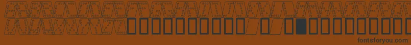Шрифт DominoNormalKursivOmrids – чёрные шрифты на коричневом фоне