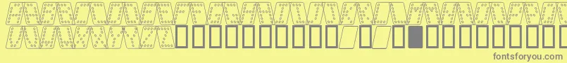 DominoNormalKursivOmrids-fontti – harmaat kirjasimet keltaisella taustalla