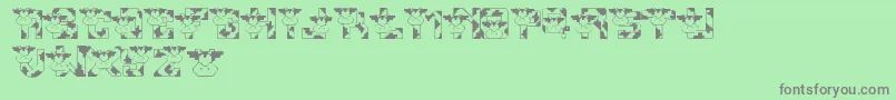 LmsConradsCows-fontti – harmaat kirjasimet vihreällä taustalla