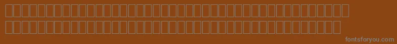 Wpro10na-fontti – harmaat kirjasimet ruskealla taustalla