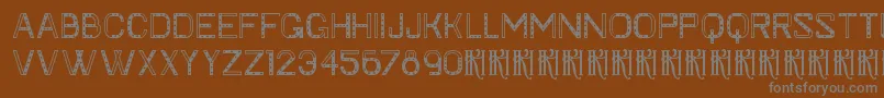 KhFaygt-fontti – harmaat kirjasimet ruskealla taustalla