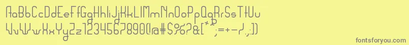 Sanserifing-fontti – harmaat kirjasimet keltaisella taustalla
