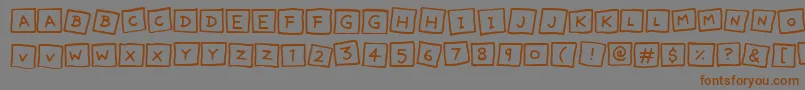 フォントCuteNotes – 茶色の文字が灰色の背景にあります。
