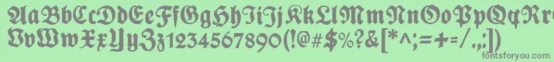 PlakatFrakturunz1l-fontti – harmaat kirjasimet vihreällä taustalla