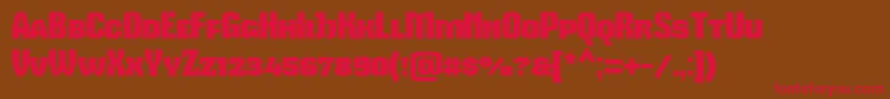 フォントMikodacspcs – 赤い文字が茶色の背景にあります。