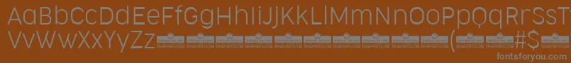 fuente CocogooseNarrowUltralightTrial – Fuentes Grises Sobre Fondo Marrón