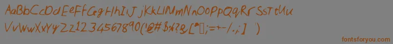 フォントNic – 茶色の文字が灰色の背景にあります。