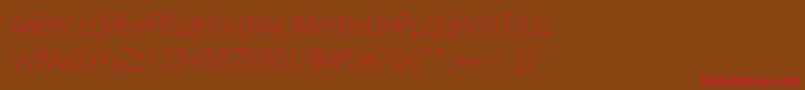 フォントPfhandbookproExtrathin – 赤い文字が茶色の背景にあります。