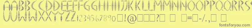 SpringyFancy-fontti – harmaat kirjasimet keltaisella taustalla