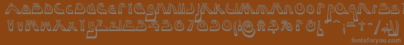 Layaway-fontti – harmaat kirjasimet ruskealla taustalla