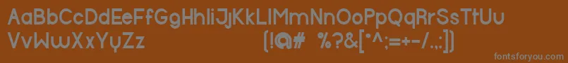 HalfmoonBold-fontti – harmaat kirjasimet ruskealla taustalla