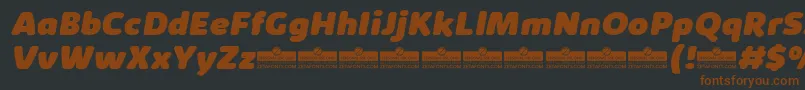 KabrioAbarthHeavyItalicTrial-fontti – ruskeat fontit mustalla taustalla