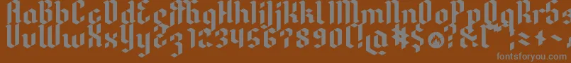 Dreifraktur-fontti – harmaat kirjasimet ruskealla taustalla