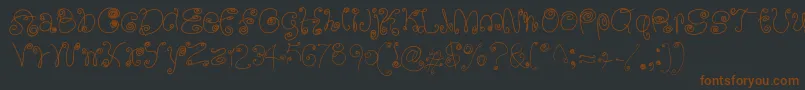 Шрифт SquigglyLittleWiggly – коричневые шрифты на чёрном фоне