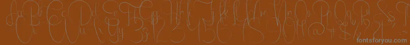 EmanuelaLight-fontti – harmaat kirjasimet ruskealla taustalla