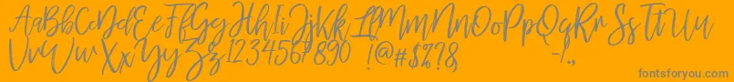 MellonyDryBrush-Schriftart – Graue Schriften auf orangefarbenem Hintergrund