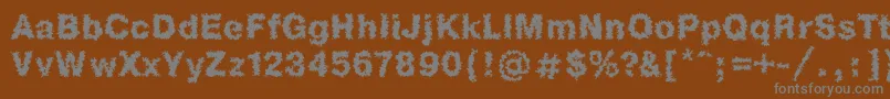 Heb1Db-fontti – harmaat kirjasimet ruskealla taustalla
