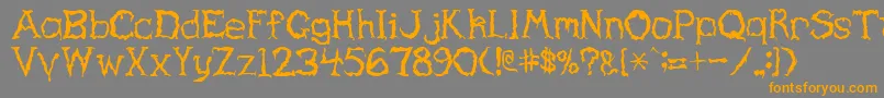 フォントHaunted – オレンジの文字は灰色の背景にあります。