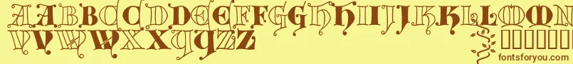 フォントKingthings Versalis – 茶色の文字が黄色の背景にあります。