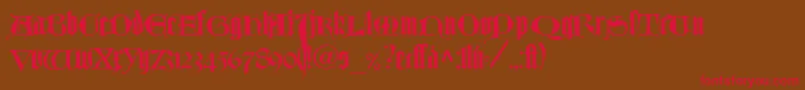 フォントTexturlombardischLtDfr – 赤い文字が茶色の背景にあります。