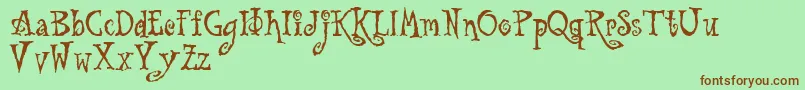 Tu-Schriftart – Braune Schriften auf grünem Hintergrund