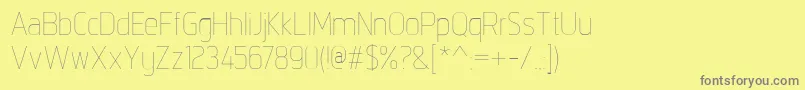 フォントIntropolThin – 黄色の背景に灰色の文字