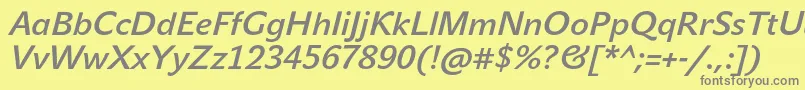 JohnsansMediumProItalic-fontti – harmaat kirjasimet keltaisella taustalla